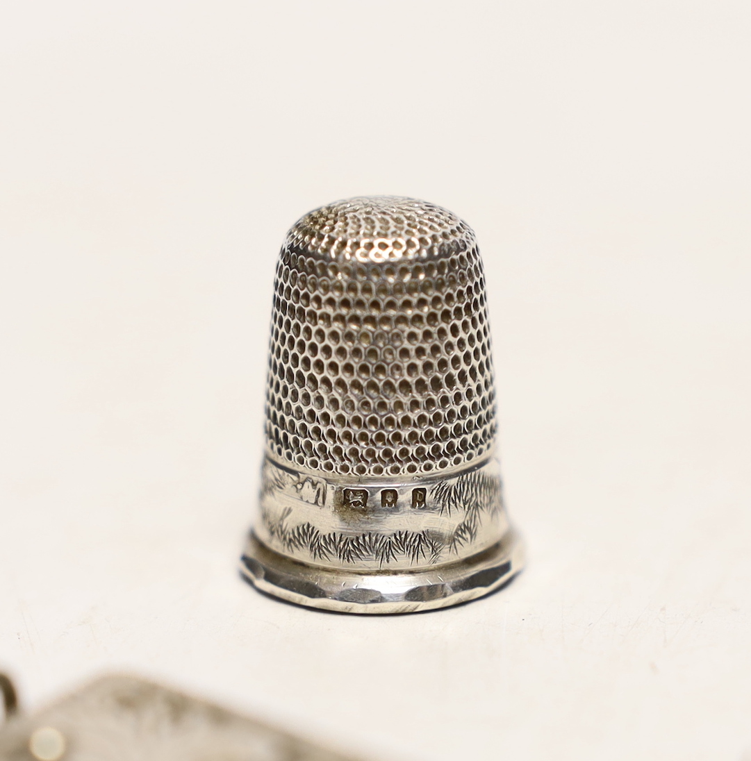 An unmarked white metal caddy spoon, modelled as a jockey's cap, 52mm, together with a silver thimble and silver mounted pocket knife.